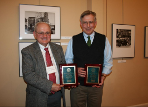 Picture of two men, Dr. Brown and Dr. Steponaitis, each holding an award plaque, smiling.