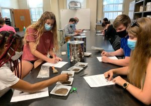 students examining soil samples